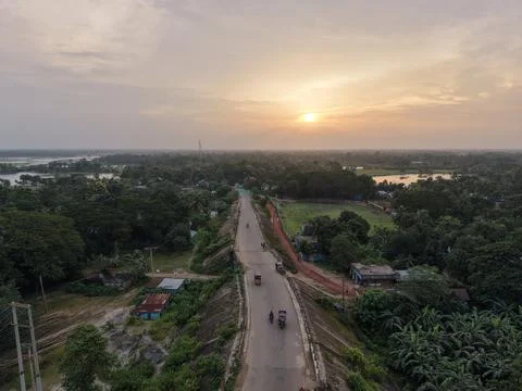 High aerial drone view of an elevated rural highway at golden hour sunset Stock Photos