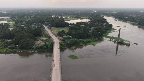 High aerial drone view of a long road bridge over a wide river in a village Stock Footage 341520581