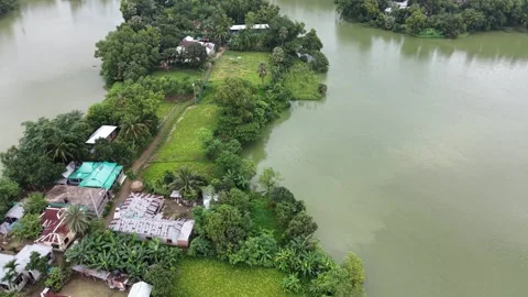 High aerial drone view of a lush green peninsula surrounded by a calm river Stock Footage 341514612
