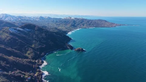 High Aerial Flight Between Snowy Mountains and Blue Sea 스톡 동영상 343443770