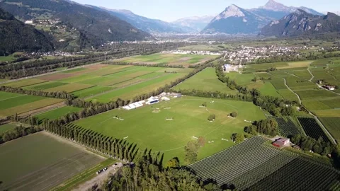High aerial orbit around equestrian event grounds in valley Stock Footage 331880941