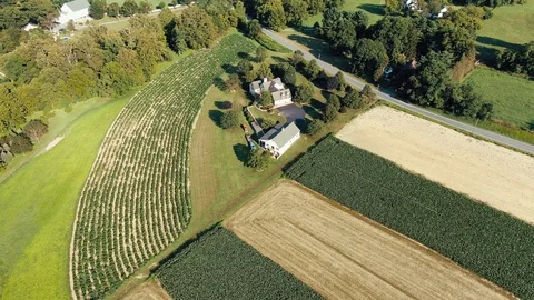 High aerial orbiting shot of Lancaster County Pennsylvania farm growing Stock Footage 115383853