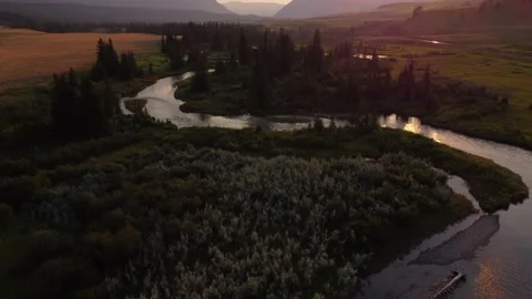 High aerial over the Crowsnest River with distant Canadian Rocky Mountains Stock Footage 204118838
