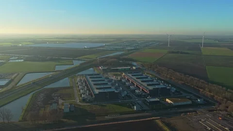 High aerial perspective of a large data center complex surrounded by rural Видео 332680810