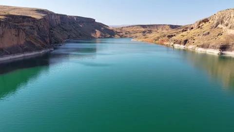 High Aerial Pullback Revealing Canyon Reflections on Turquoise Lake Stock Footage 340131554