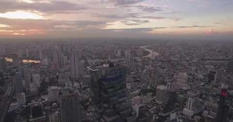 High Aerial Pullback Shot Over Bangkok City Center Skyline and River at Dusk Stock Footage 76034605