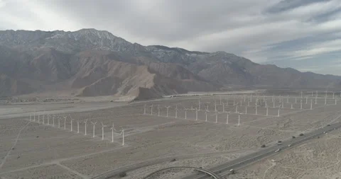 High aerial pulls back over highway 10 and the white windmills by Palm Springs Stock-Footage 150912910