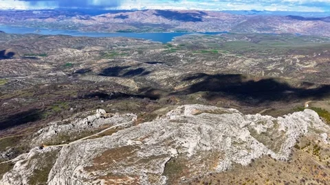 High Aerial Quarter Orbit Over Rocky Landscape with River and Mountains Stock-Footage 342157730