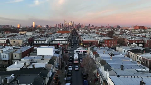 High aerial reveal pull back of buses driving in South Philadelphia during Video stock 231462408