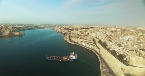 High Aerial Shot of a car exiting the city Stock Footage 61340816