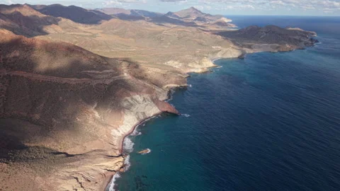 High aerial shot of the cliffs and bays in Cabo de Gata National Park 動画素材 312041805