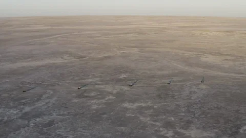 High aerial side view of tourists having fun driving quad bikes in the wide open Stock Footage 107220583