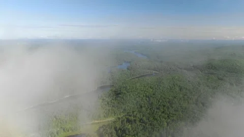 High aerial through low clouds above forested lakes in Mont Tremblant, Quebec Stock Footage 208808185
