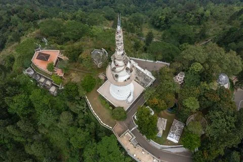 High aerial top-down view of the unique spiral Tower surrounded by lush green Stock Photos