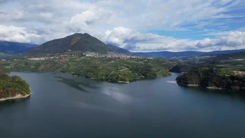 High aerial tracking shot over Santa Giustina Lake with Cagnò and Revò villages Stock Footage 331687268