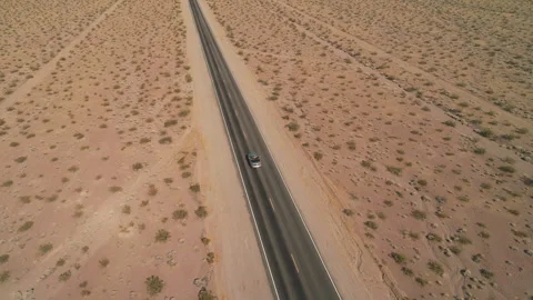 High Aerial View of Car on Desert Road Stock Footage 327338901