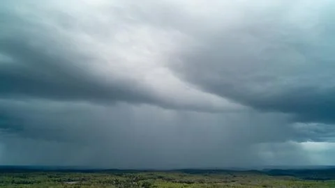 High Aerial View of Massive Active Rain Downpour and Storm Clouds Over Forest Stock-Fotos