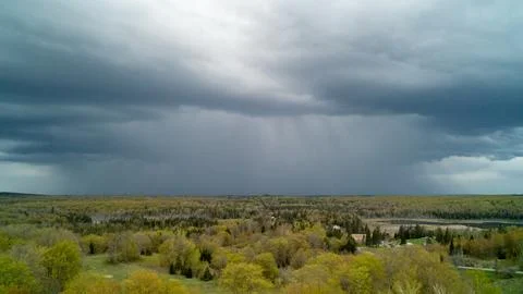 High Aerial View of Massive Active Rain Downpour and Storm Clouds Over Forest Foto stock