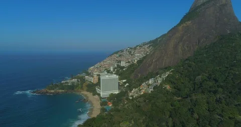 High aerial view over forest of mountain, beach, ocean, favelas and luxury Vídeo Stock 126114036