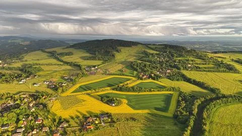 High aerial view over patchwork farmland with rolling fields, winding roads.. Stock Photos