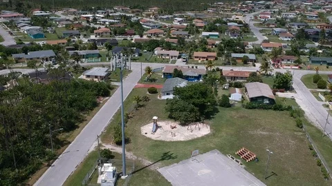 High Aerial View of Pioneers Loop Cell Tower and Neighborhood, Freeport Bahamas Stock Footage 90105486
