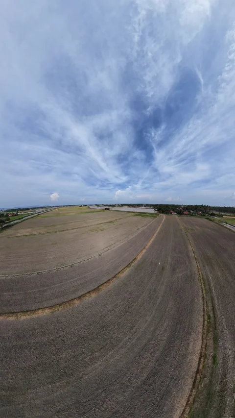 High aerial view shows vast farmland under blue sky Stock Footage 345408185
