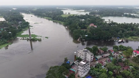 High aerial view of a wide river bend with a brick chimney and rural town Stock Footage 341520664