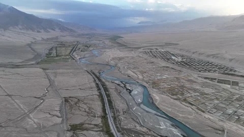 High aerial view of winding mountain road through dry canyon in Xinjiang China Stock Footage 337681015