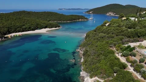 High altitude 4K drone view of scenic Ionian sea bay and dense pine forest in Gr Stock Footage 340567320