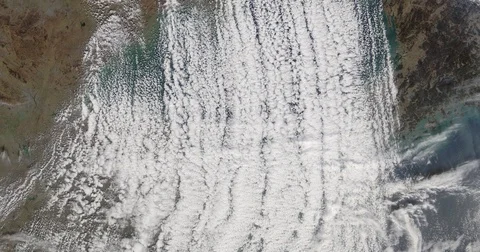 High-altitude aerial of cumulus cloud streets covering the Yellow Sea Stock-Footage 84240640