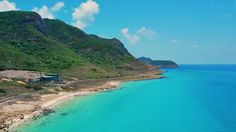 High altitude aerial panorama of empty winding road on tropical coast 4K Stock Footage 337152448