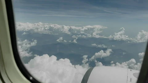 High Altitude Aerial View of Clouds and Jet Engine from Airplane Window Stock Footage 337949085