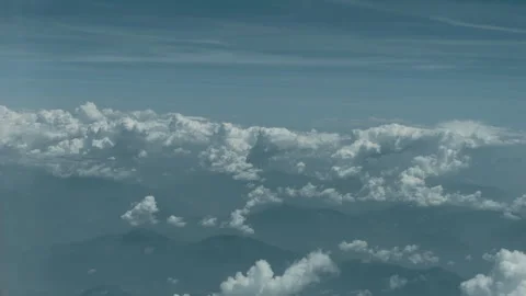 High Altitude Aerial View of Fluffy Clouds Over Mountains Stock Footage 337947366