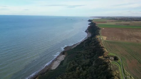 High altitude aerial view of the rugged Normandy coastline near Arromanches Stock Footage 330668572
