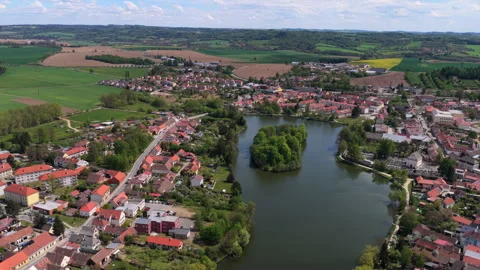 High-altitude aerial view of a small Czech town with red-roofed houses, a wooded Stock Footage 336622265