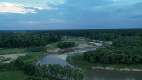 High altitude aerial view of winding river passing through dense green fore.. Video stock 342448811