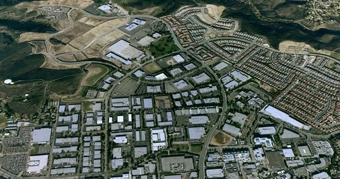 High-altitude circular tracking shot of a small city plant Stock Footage 97178536