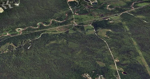 High-altitude circular tracking shot of a rural road Stock Footage 97199092