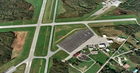 High-altitude circular tracking shot of a small airport Stock Footage 97231978