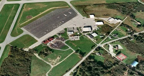 High-altitude circular tracking shot of small airport hangars Video stock 97232710
