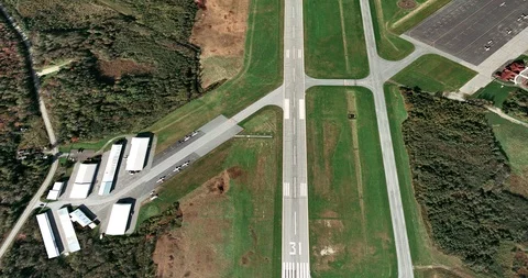 High-altitude circular tracking shot of small airport runways Stock Footage 97234842