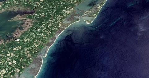 High-altitude circular tracking shot of Wallops Island, Virginia Видео 97323634