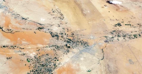 High-altitude circular tracking shot of Arabian Desert farms Stock Footage 97454543