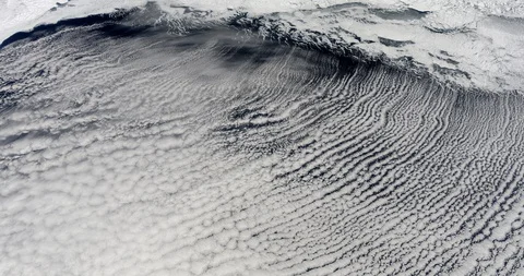 High-altitude circular tracking shot of clouds over the Bering Strait Video stock 97669475