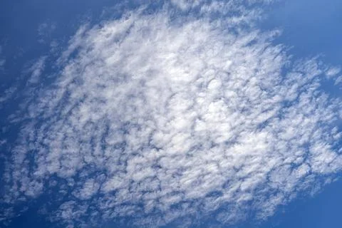 High altitude cirrocumulus cloud formation pattern across clear blue sky Stock Photos