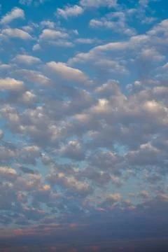 High-altitude clouds forming in the evening sky, vertical shot Stock Photos