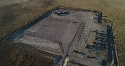 High altitude downshot over a mostly empty fracking pad during the late Stock Footage 167931287