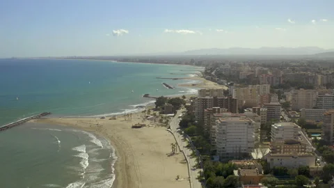 High altitude drone booming down from seafront overview onto  sandy beach 스톡 동영상 150406994