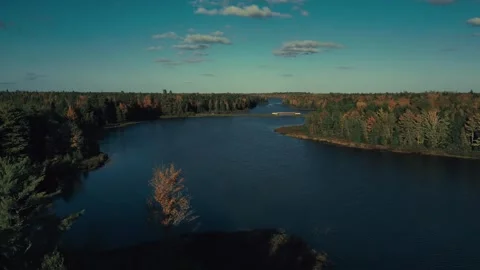 High Altitude Drone Flight Out Over A Beautiful Lake Surrounded By Trees Video stock 255168432