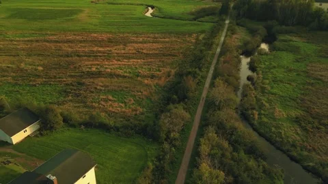 High Altitude Drone Flight Over Roadway, Green And Brown Fields And A River Stock Footage 255310782